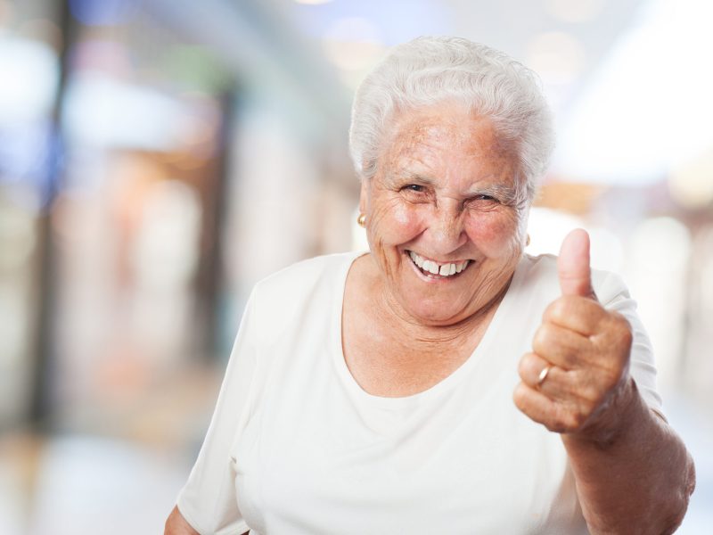 happy old woman with thumb up closeup